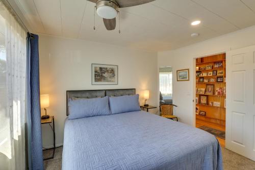 a bedroom with a large bed with blue sheets at Downtown Carlsbad Apartment Less Than half Mi to Beach! in Carlsbad