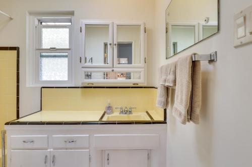 a bathroom with a sink and a mirror at Downtown Carlsbad Apartment Less Than half Mi to Beach! in Carlsbad