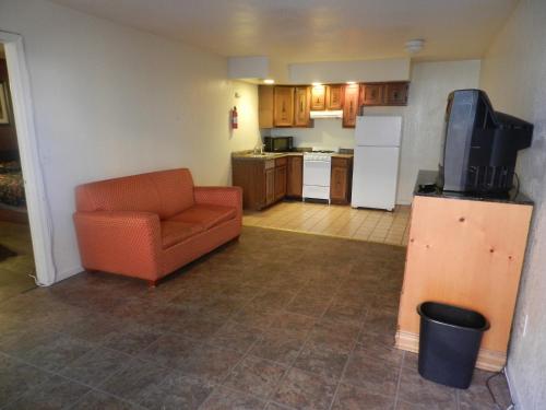 a living room with a couch and a kitchen at Seagem Motel and Apartments in Seaside Heights