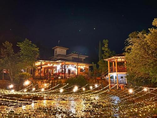 a building with lights in front of it at night at Cabaña Casa Cantabria in Villa de Leyva