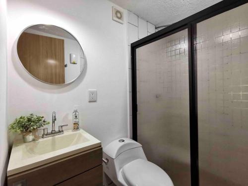 a bathroom with a toilet and a sink and a mirror at Estudio 2 personas en el Centro/agencias aduanales in Veracruz