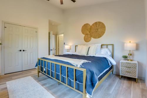 a bedroom with a large bed with blue comforter at Modern Graford Cabin Walk to Possum Kingdom Lake! in Graford
