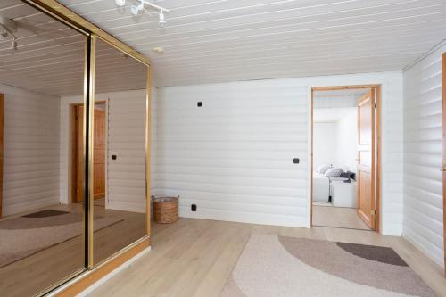 a room with a glass door leading to a bathroom at Spacious house near santapark in Rovaniemi