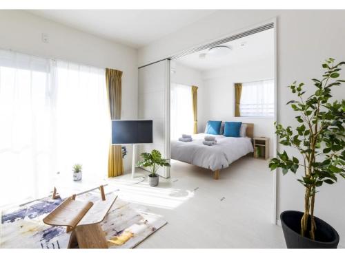a bedroom with a bed and a large mirror at Vent du Vent 5F - Vacation STAY 83698v in Urasoe