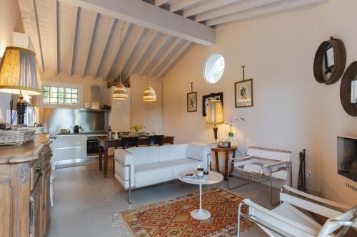 a living room with a white couch and a kitchen at Monteaperto in Barberino di Mugello