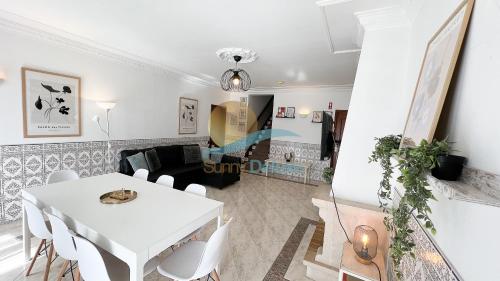 a living room with a white table and chairs at Villa Bea by Sunny Deluxe in Albufeira
