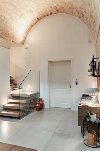 a living room with a staircase and a brick ceiling at Le Vie Del Centro Luxury Room in Matera