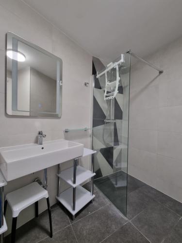 a bathroom with a sink and a shower at LUX VISTA Suite in Umag