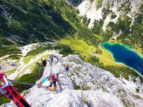 a woman laying on a rock on a mountain at Chalet im Rad - Wanderparadis Tiroler Zugspitze Arena in Ehrwald