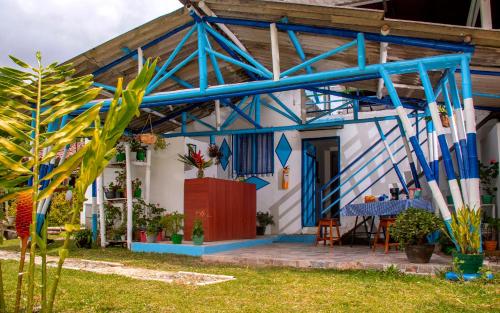 a house with a blue and white at Secretos del Eden in Ruiosucio