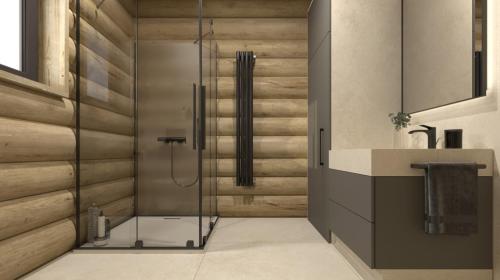 a bathroom with a shower with a glass door at Grand Chalet Donovaly in Donovaly