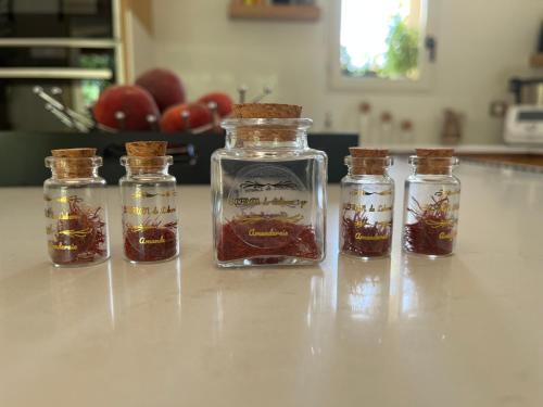 a group of four glass jars filled with honey at L'AMANDERAIE PISCINE PRIVEE à côté de LOURMARIN LUBERON in Cadenet