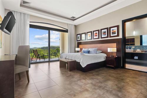 a hotel room with a bed and a balcony at Villa Buena Onda All Inclusive in Coco