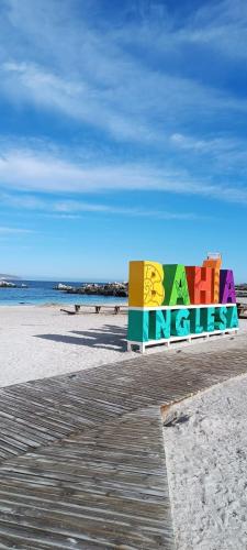 a sign on a beach with the words kerkkiss at Aldea Bahiguana Piso Privado 5 personas in Bahia Inglesa