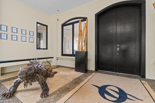 a living room with a dinosaur statue in front of a door at Villa Buena Onda All Inclusive in Coco