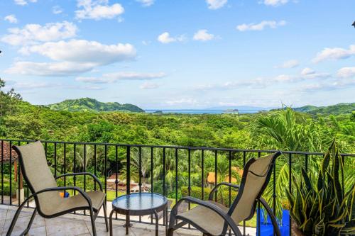 a balcony with chairs and a table and a view at Villa Buena Onda All Inclusive in Coco