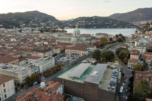 an aerial view of a city with a river and buildings at DANTE SUITE in Como