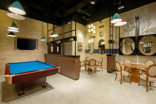 a billiard room with a pool table and a bar at Marriott Executive Apartments City Center Doha in Doha