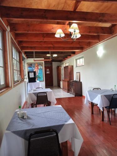 a room with two tables and chairs in a building at Casona Patrimonial Cobquecura Hotel Boutique in Cobquecura