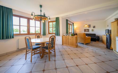 a kitchen and living room with a table and chairs at Landhaus Bellevue in Ramsau am Dachstein