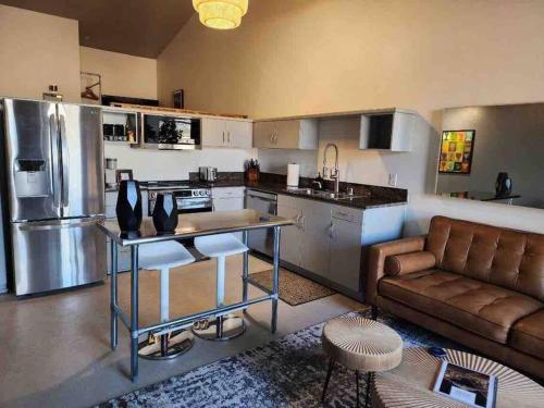 a kitchen and living room with a couch and a table at San Diego Gaslamp Loft Getaway in San Diego