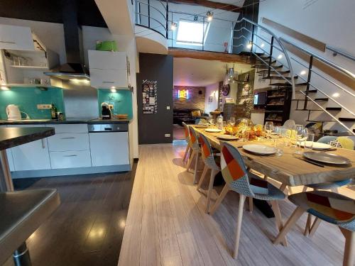 a kitchen and dining room with a table and chairs at La Renaissance 1&2 high standing guest house in Herve