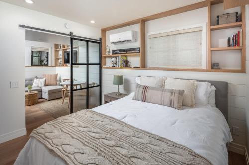 a bedroom with a large bed and a living room at Neptune Charm in Encinitas