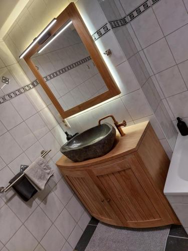 a bathroom with a black sink and a mirror at La Renaissance 1&2 high standing guest house in Herve