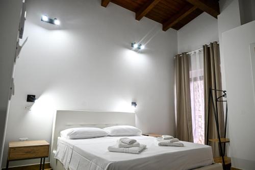 a bedroom with a white bed with towels on it at Borgo Caridà - Green Family Holidays in Zaccanopoli