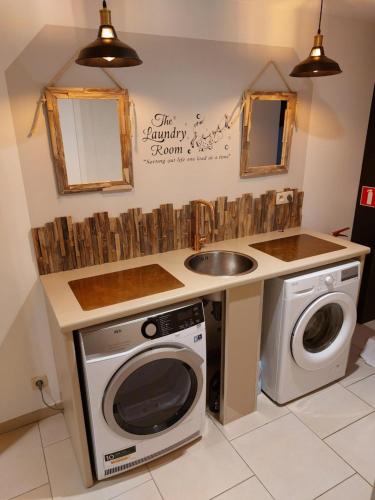 a kitchen with a sink and a washing machine at La Renaissance 1&2 high standing guest house in Herve