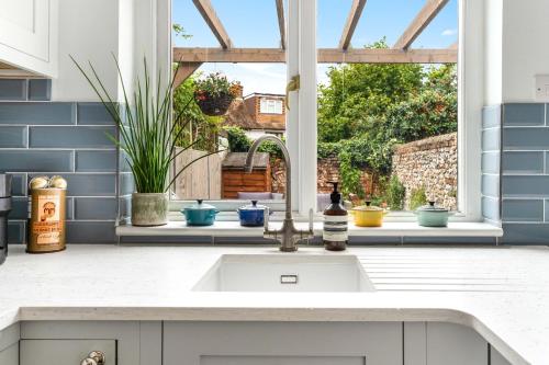 a kitchen with a sink and a window at Little Braybrooke Cottage in Saffron Walden