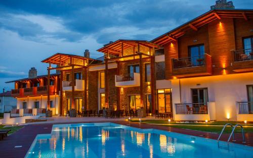 a house with a swimming pool in front of it at Irene's Resort in Kato Loutraki