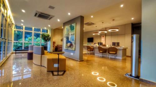 a large room with a kitchen and a living room at LS Villas Tranquillità in Águas de São Pedro