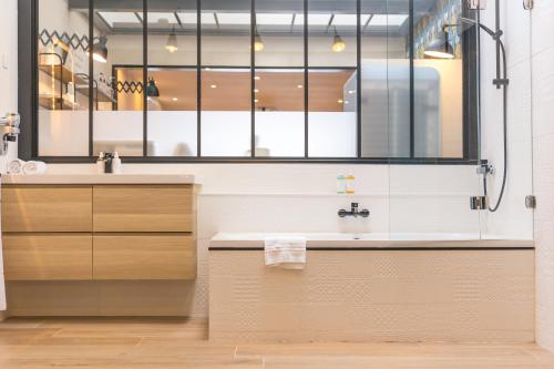 a bathroom with a sink and a mirror at Baie des Anges in Landéda