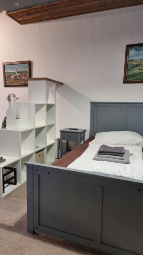 a bedroom with a large bed and a desk at Apartmán Kompas in Spišské Podhradie