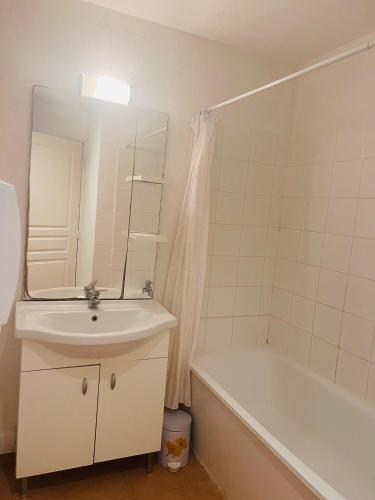 une salle de bain avec un lavabo, une baignoire et un miroir dans l'établissement La villa De Lina 508 -Self Check In -, à Gallargues-le-Montueux