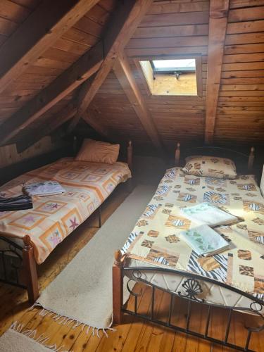 two beds in a room with a attic at Restoran Domaćin in Bosanski Novi