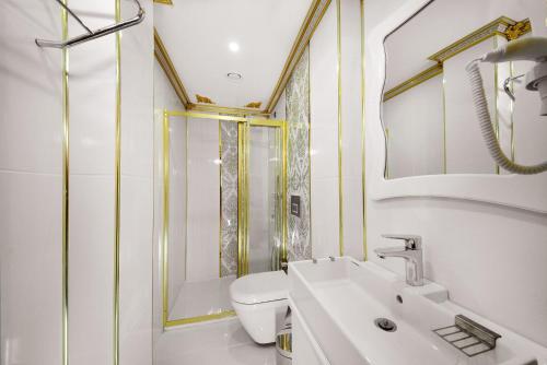 a bathroom with a toilet and a sink and a shower at Babel Park Hotel in Istanbul