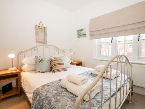 a bedroom with a white bed with pillows at Holmleigh, Aldeburgh in Aldeburgh