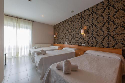 Un pat sau paturi într-o cameră la Hotel Casa Jurjo
