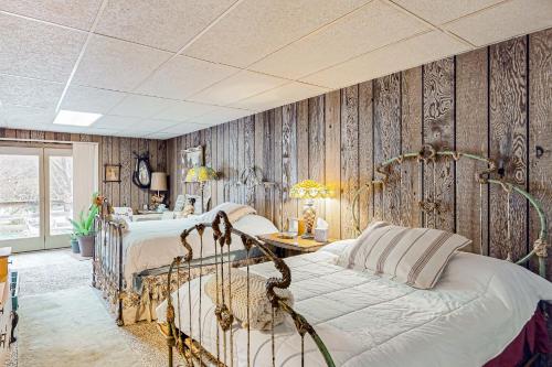 a bedroom with wooden walls and a bed and a table at Red Barn Retreat 