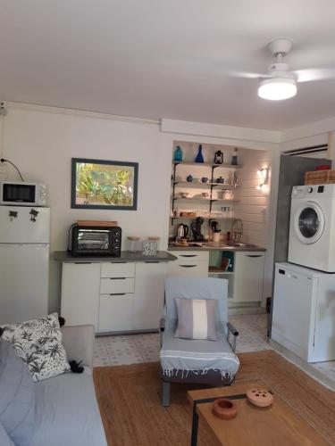 a living room with a couch and a microwave at Casefilo in Sainte-Luce