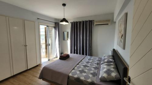 a bedroom with a bed and a large window at Modern Cityscape Home in Nicosia