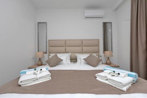 a bedroom with a large bed with towels on it at Family & Child friendly Villa Violet with Salt water pool in Makarska