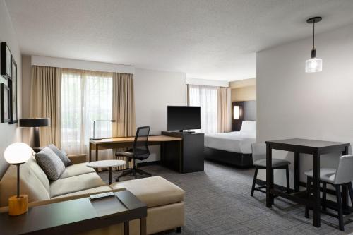 a hotel room with a bed and a living room at Residence Inn by Marriott Madison West/Middleton in Middleton