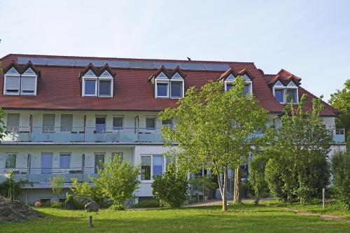a large white building with a red roof at Landhotel Hauer in Pleisweiler-Oberhofen