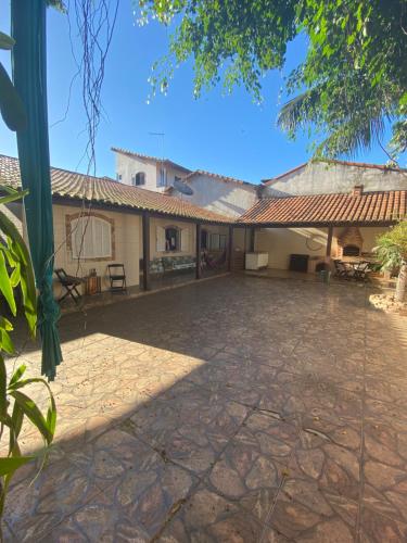 a house with a large patio in front of it at Los gringos del caribe in Saquarema