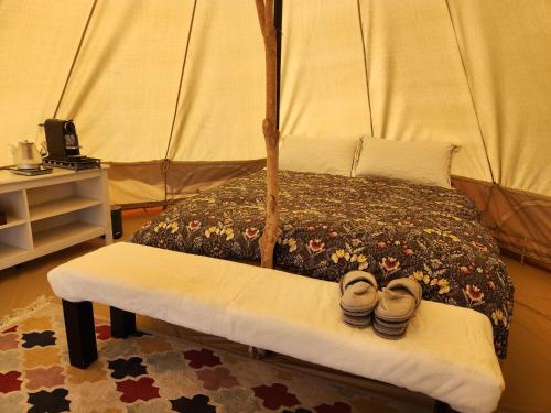 A bed or beds in a room at Two Little Piggies Glamping