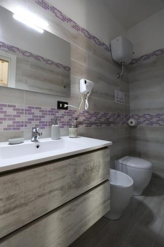 a bathroom with a sink and a toilet at B&B Royal Palace of Napoli & Reggia di Caserta in Caserta