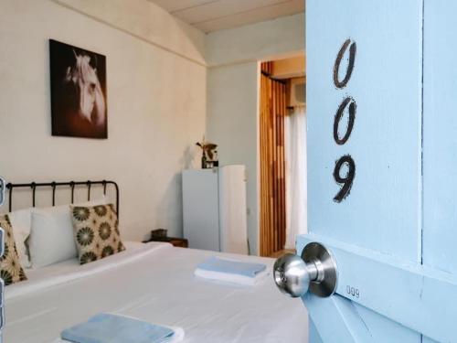 a bedroom with a white bed and numbers on the wall at De Lit in Ubon Ratchathani